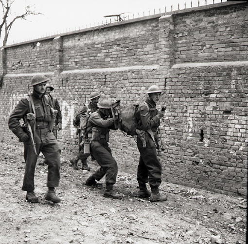 arms_land_infantry_radio_1 Edmonton Regiment soldiers use walkie-talkie during advance in Ortona, Italy, 21 December 1943. Carrying it is Lance Corporal W. D. Smith. Talking into it is Private W. L. Waske.