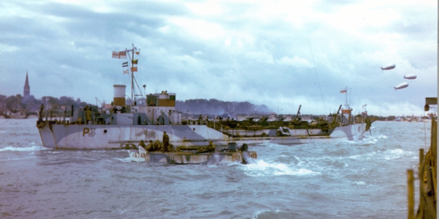 A Landing Craft Tank (LCT), loaded with Sherman tanks belonging to 2nd Canadian Armoured Brigade, sails along the coast off Bernières-sur-Mer. The Church steeple in the centre of the town is visible at the left edge of the photo. A much smaller Landing Craft Assault (LCA) putters past in front of the LCT. Source: Library and Archives Canada CT 305 / Courtesy of the Juno Beach Centre Association Colour photograph. A Landing Craft Tank (LCT), loaded with Sherman tanks belonging to 2nd Canadian Armoured Brigade, sails along the coast off Bernières-sur-Mer. The Church steeple in the centre of the town is visible at the left edge of the photo. A much smaller Landing Craft Assault (LCA) putters past in front of the LCT. Source: Library and Archives Canada CT 305 / Courtesy of the Juno Beach Centre Association