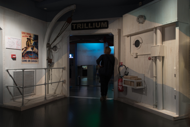 Inside the Museum ©CJB-J.Duchemin Colour photo. A woman stands inside a mock naval doorway.